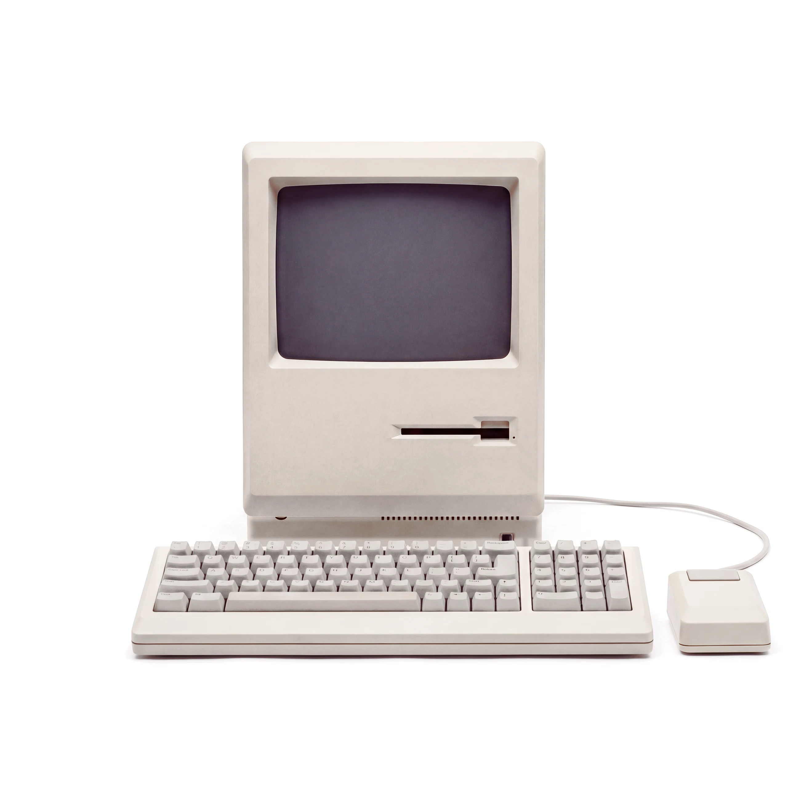 A 1986 compact all-in-one computer with its full-width keyboard, numeric keypad and mouse. On its black-and-white desktop, a week's schedule sits behind the Onroute Intelligence scheduling agent, which says: “Moved Thursday's heat pump service to Friday at 10am. Dan is nearest after his morning job, and the customer has confirmed by text. Two gaps left next week for urgent call-outs.”